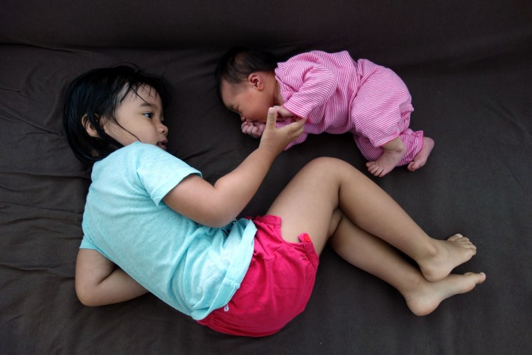 Eva and her little sister Isa, loungin' on the couch.