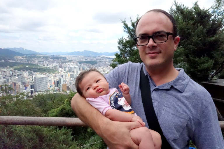 Isa and Daddy, with the place where she was born somewhere down below.