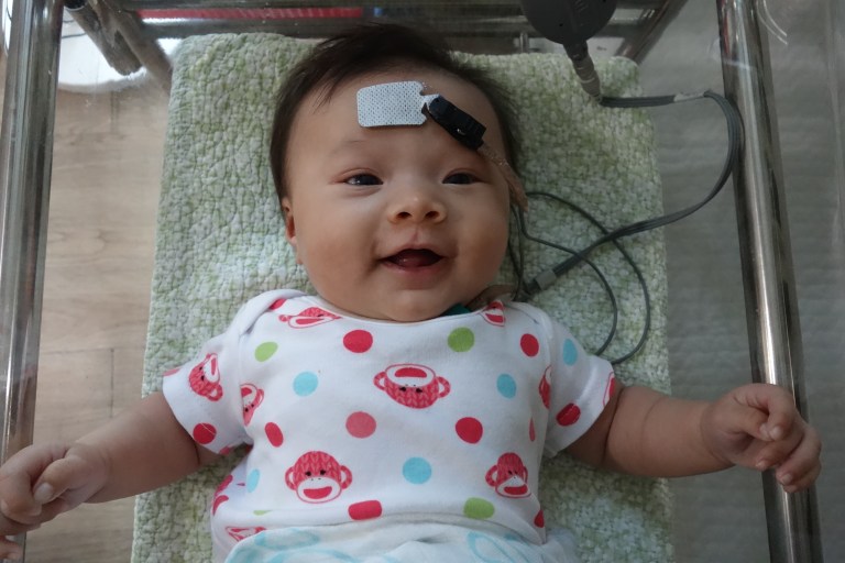 Geared up for her follow-up hearing exam.