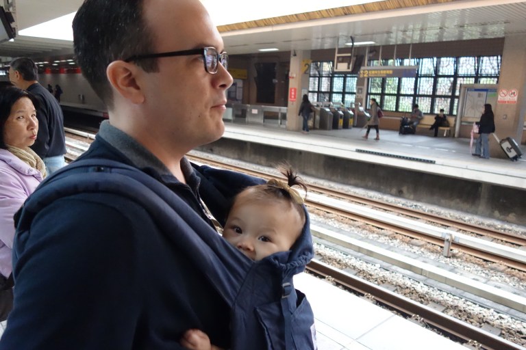 Isa and her Daddy await the Taipei metro, the MRT.