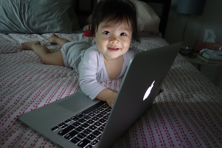 Isa is far more interested in typing on Momma's computer than her sister ever was. 