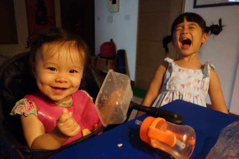 Amusing themselves during Isa's snack time at Oma and Opa's house.