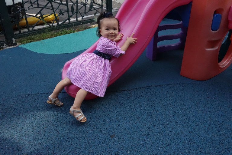 One of Isa's interests is climbing up a slide the wrong way.