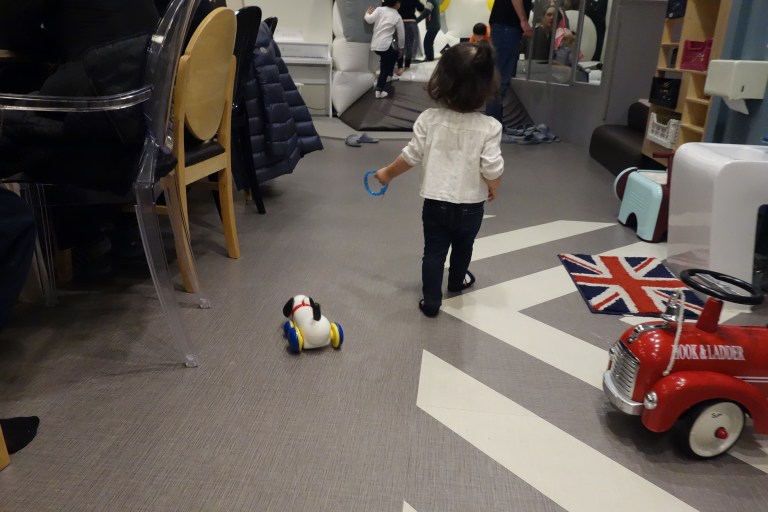 Draggin' a toy dog on a leash 'round and 'round.